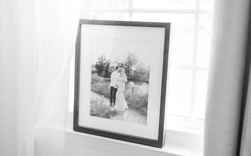 custom framed maternity photo of mom and dad snugging and holding baby belly during maternity photos