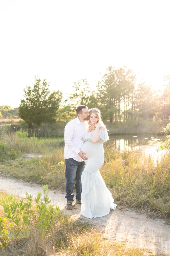 gorgeous golden hour maternity photo session on sandy trail in virginia beach during maternity photos