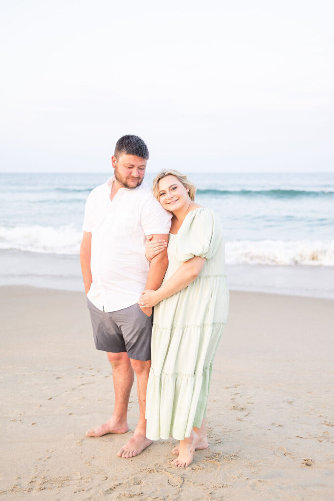 mom and dad posing for a family portrait in virginia beach during family photos on the beach