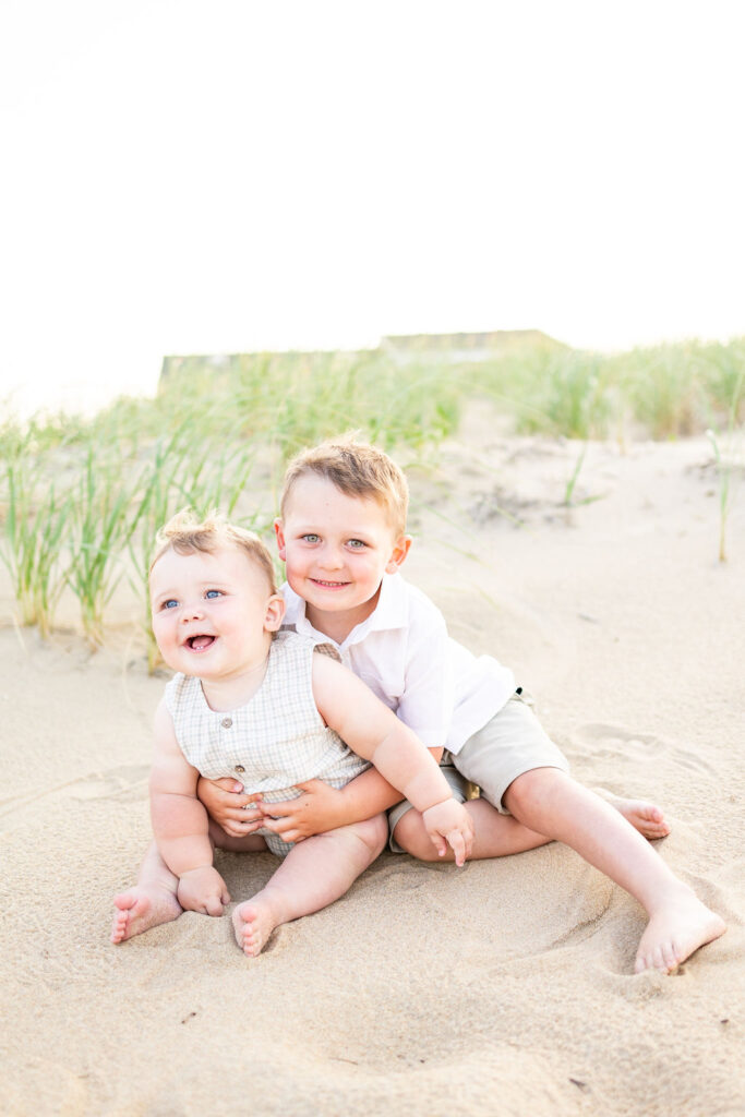 adorable virginia beach family photos featuring two siblings smiling at their momma