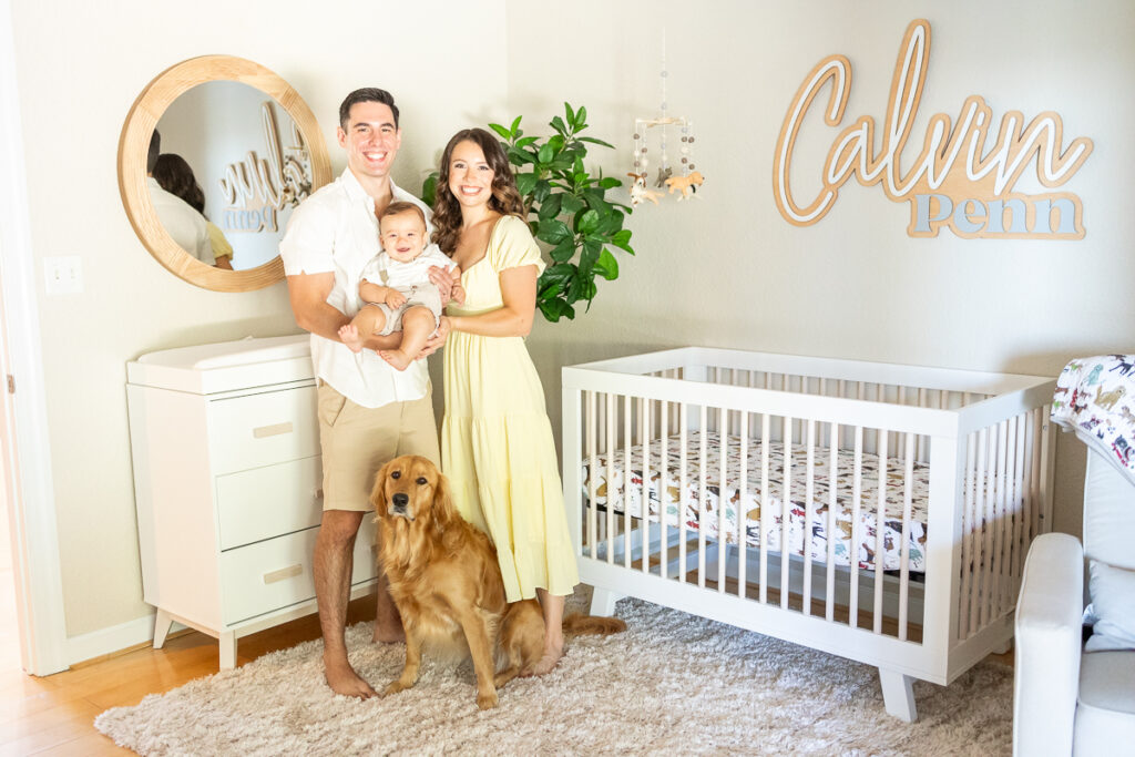 mom, dad, 7 month old baby and golden retriever smile for family photo in their home during in home family photos with chelsey kraus photography
