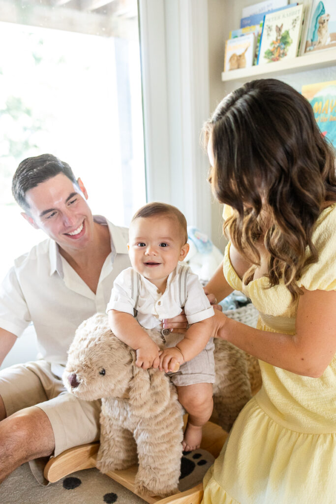 in home family photos in baby boy's nursery with mom and dad and baby