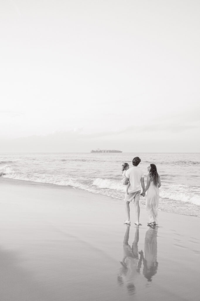 Virginia Beach Photography Locations featuring a family of three on a beach looking at the ocean.