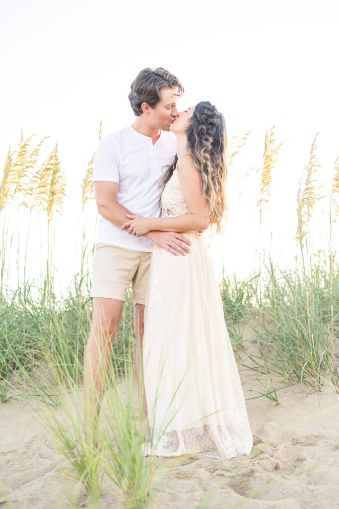 mom and dad kissing during photos on the beach