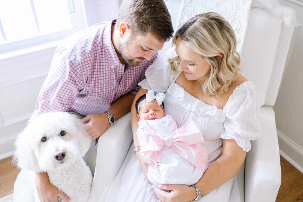Virginia Beach newborn photographer featuring a mom, dad, puppy, and sweet baby girl