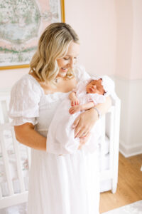mother and daughter smiling together during a newborn photography session in Virginia Beach
