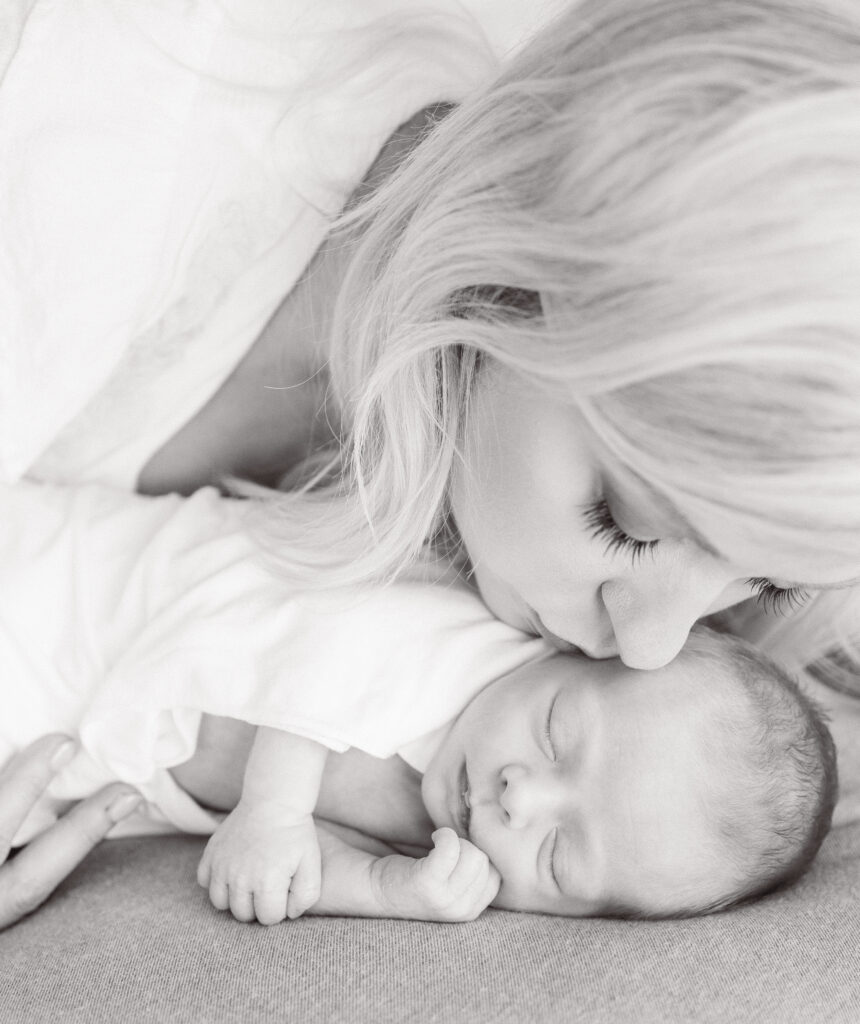 kissing her newborn on the cheek during  photoshoot in Virginia Beach