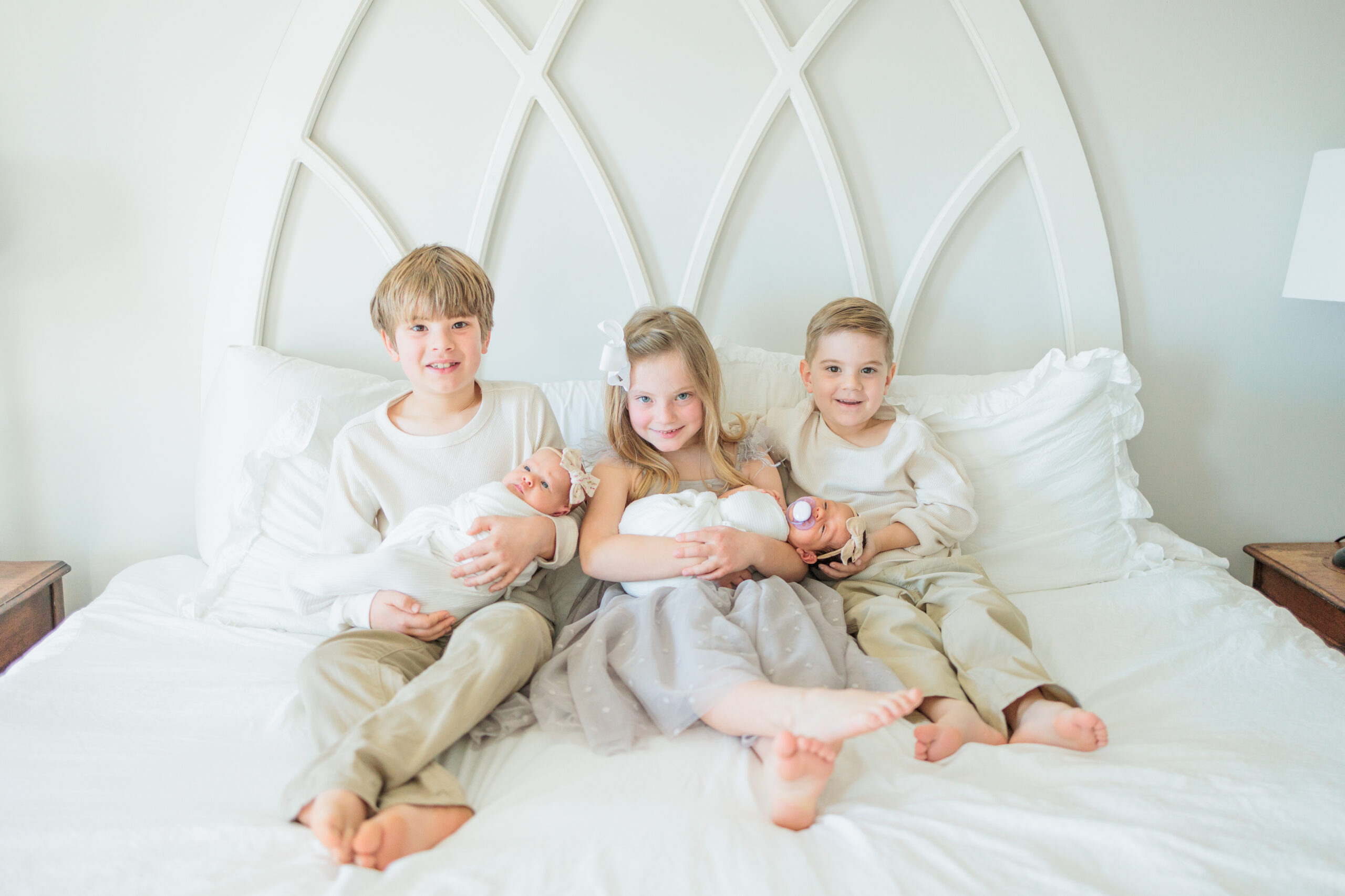 Siblings holding their new babies captured by a Virginia Beach newborn photgrapher
